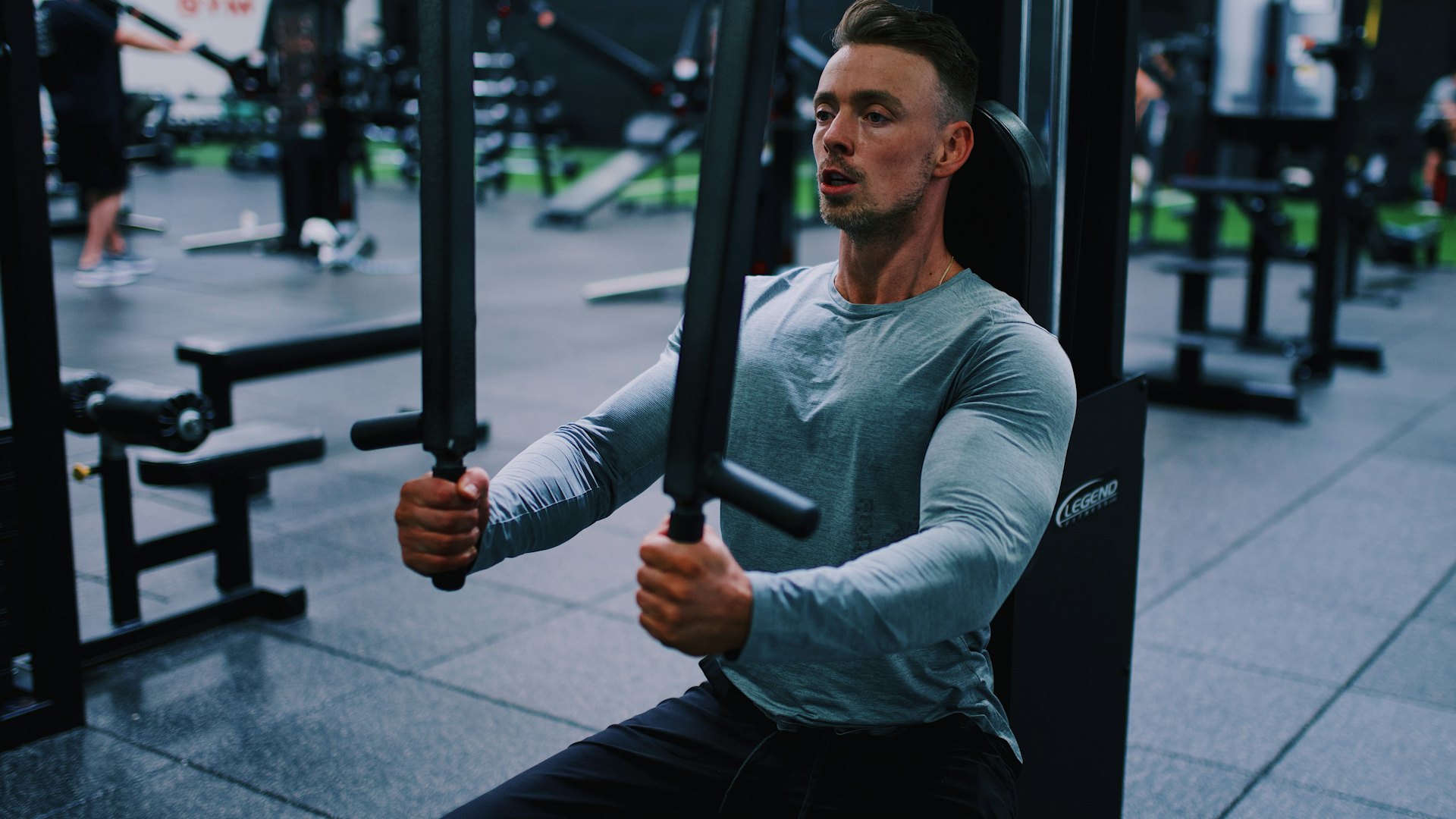 Patient rebuilding strength on a gym machine after surgery