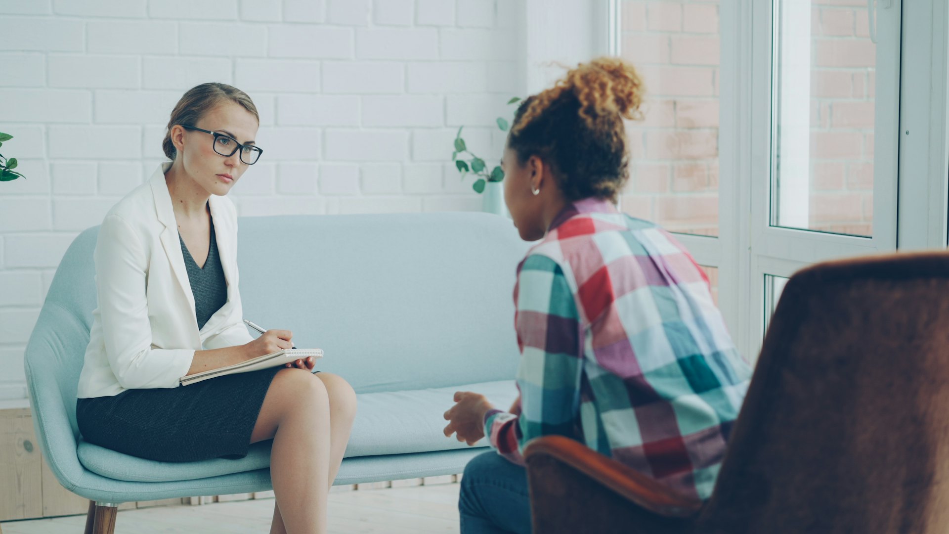 Social worker listening to a client in a counselling session